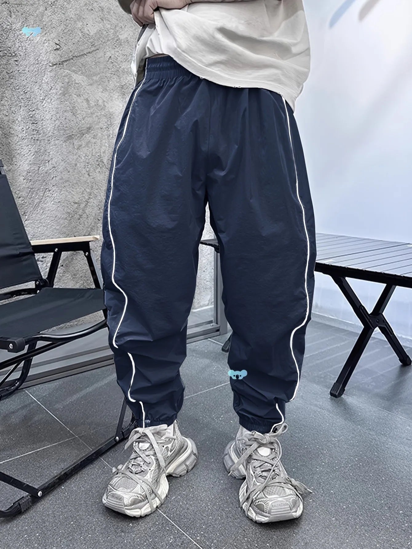 Men's blue bamboo fibre casual sports trousers with a loose, cropped fit on a neutral background.