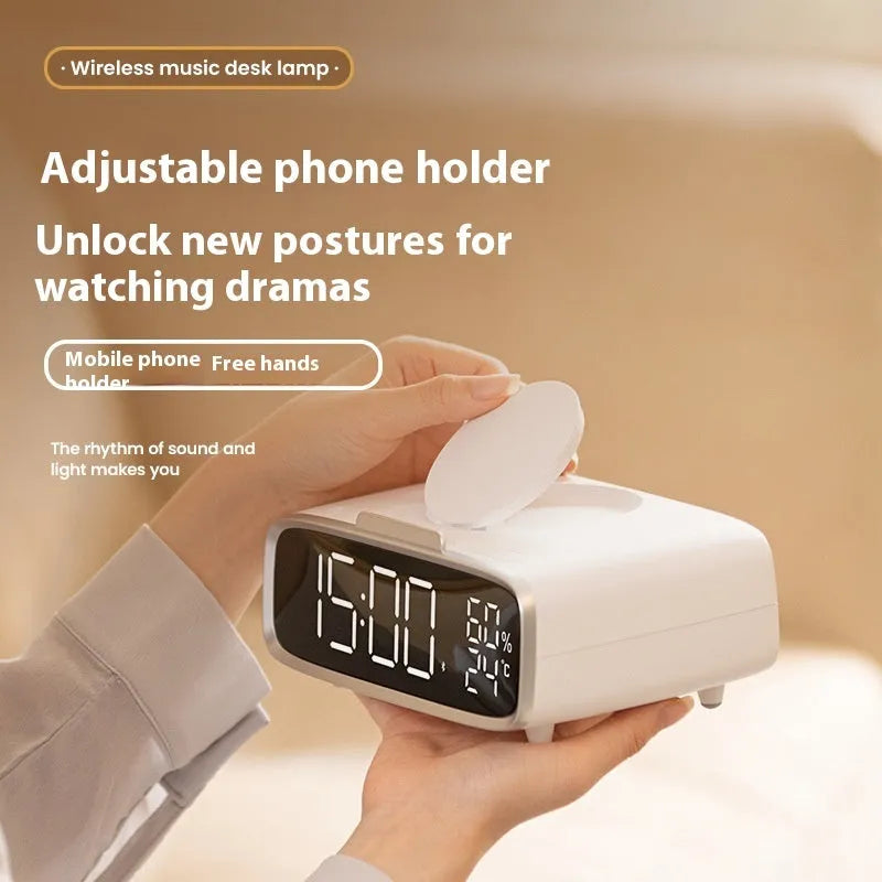 White wireless charger bluetooth speaker with LED night light and alarm clock display on flat surface