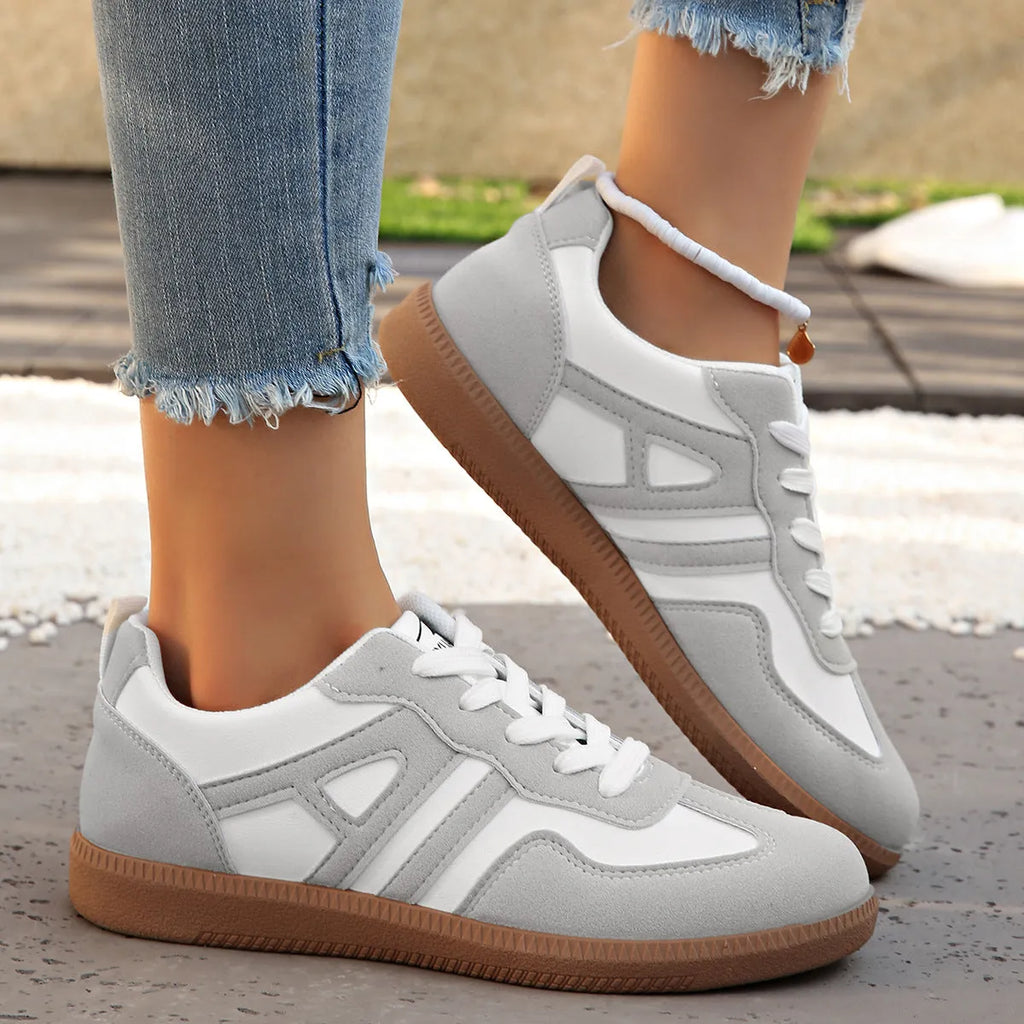 Women's retro colour matching lace-up jogging shoes in black, showing low-top design and platform heel.