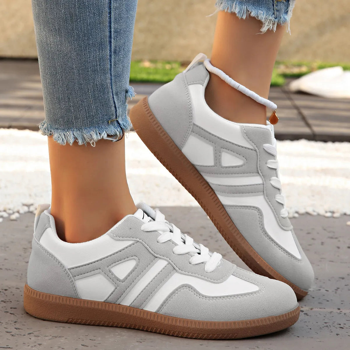 Women's retro colour matching lace-up jogging shoes in black, showing low-top design and platform heel.