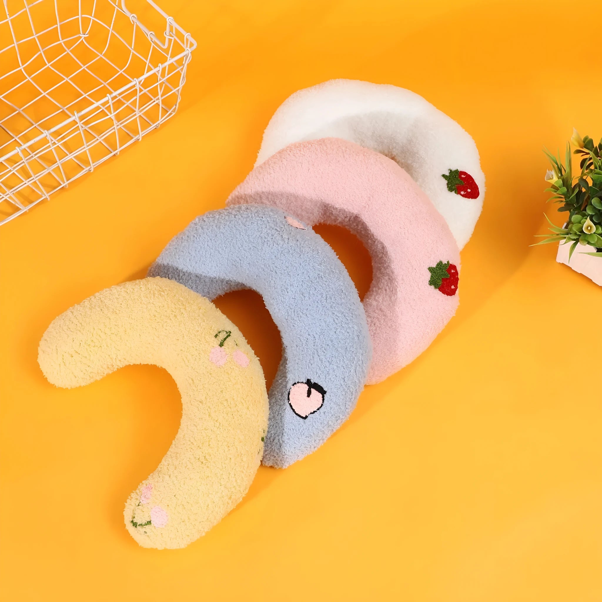 Yellow half-moon shaped cloth pillow with cartoon design for cats and dogs to sleep on.