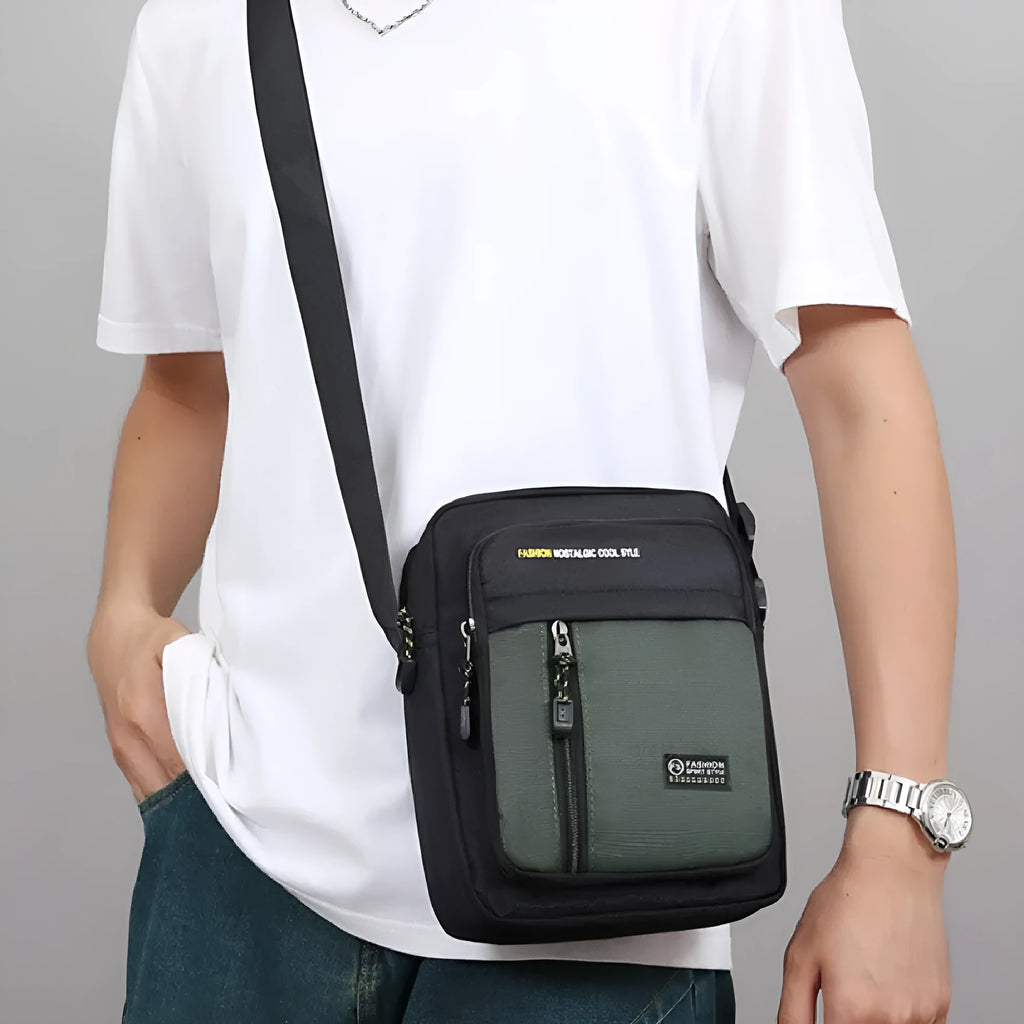 Men's casual nylon messenger crossbody bag with sewing thread detail, shown in green colour.