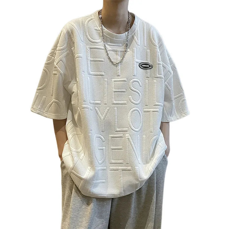 Man modelling a grey loose-fit retro T-shirt with a raised 3D summer letter print on the front.