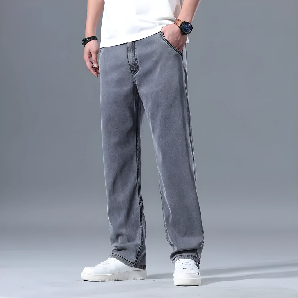Men's loose straight-leg lyocell jeans in blue and grey colour options showing zip fly detail