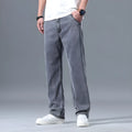 Men's loose straight-leg lyocell jeans in blue and grey colour options showing zip fly detail