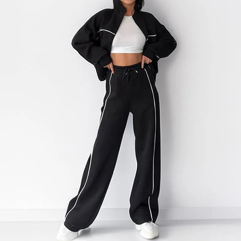 Casual polyester suit set showing a long sleeve mock neck hoodie and striped trousers on a model.