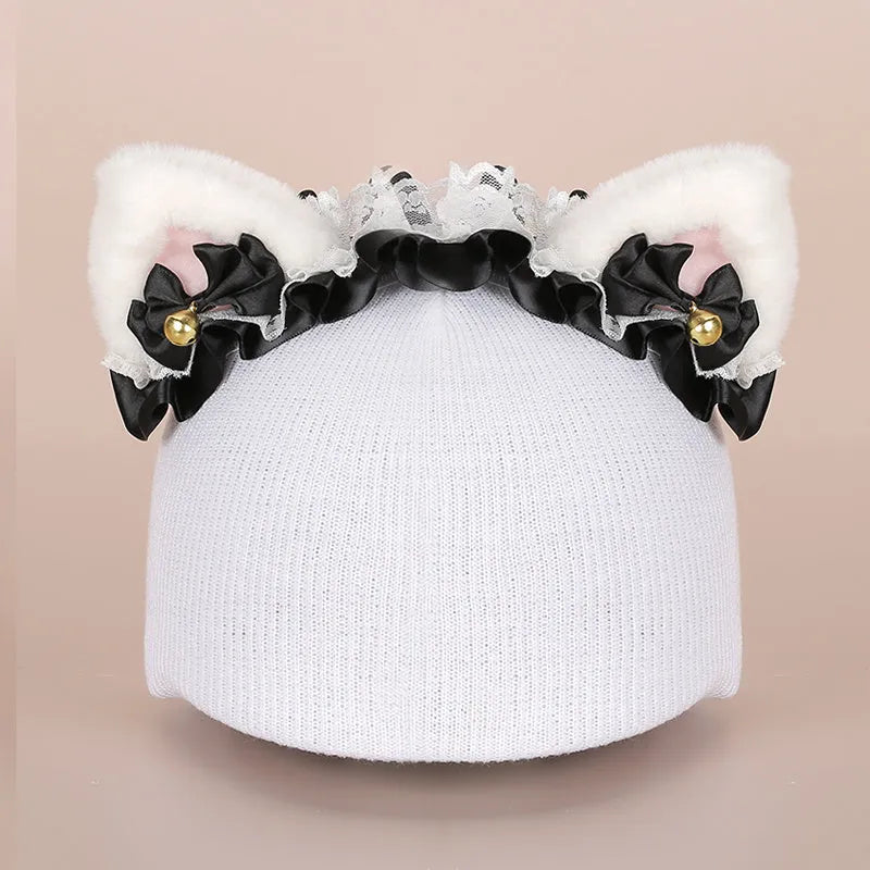 Soft plush cartoon character topper fitting over a blue ski helmet on a snowy background.