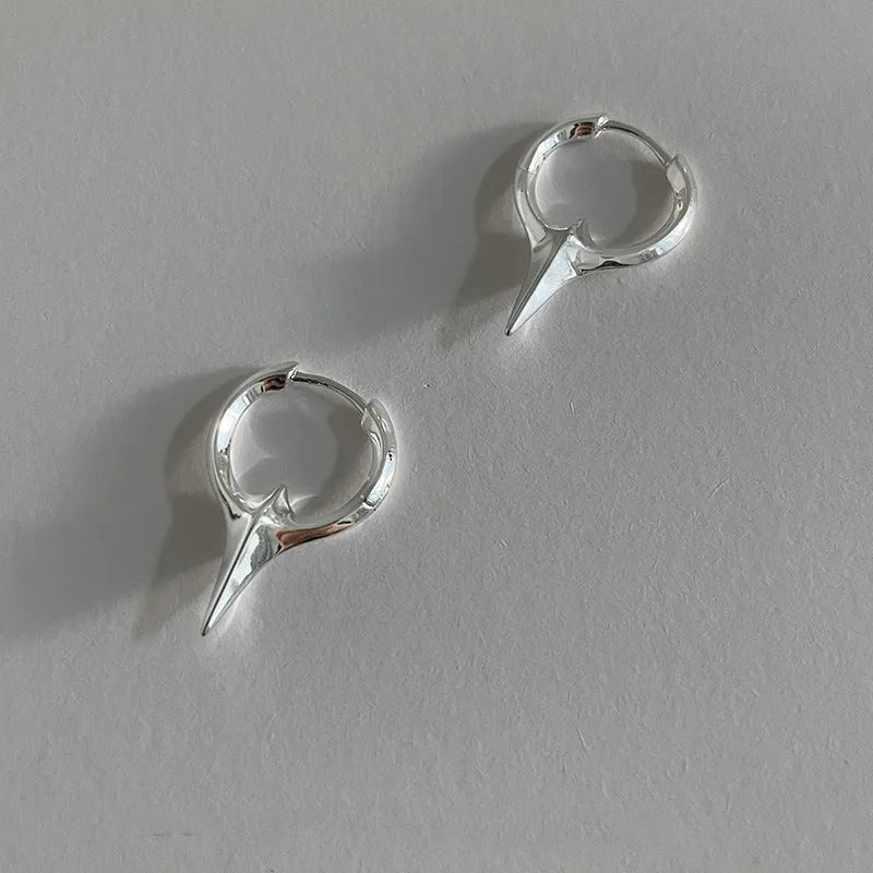 Women's geometric star-shaped clip earrings with a platinum electroplated finish on copper.