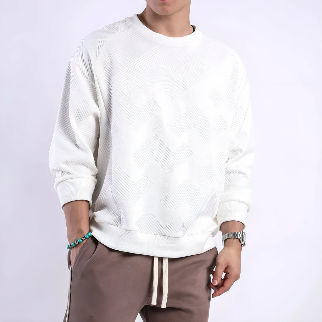 Man wearing a loose-fitting army green twill jacquard long-sleeved pullover sweater.
