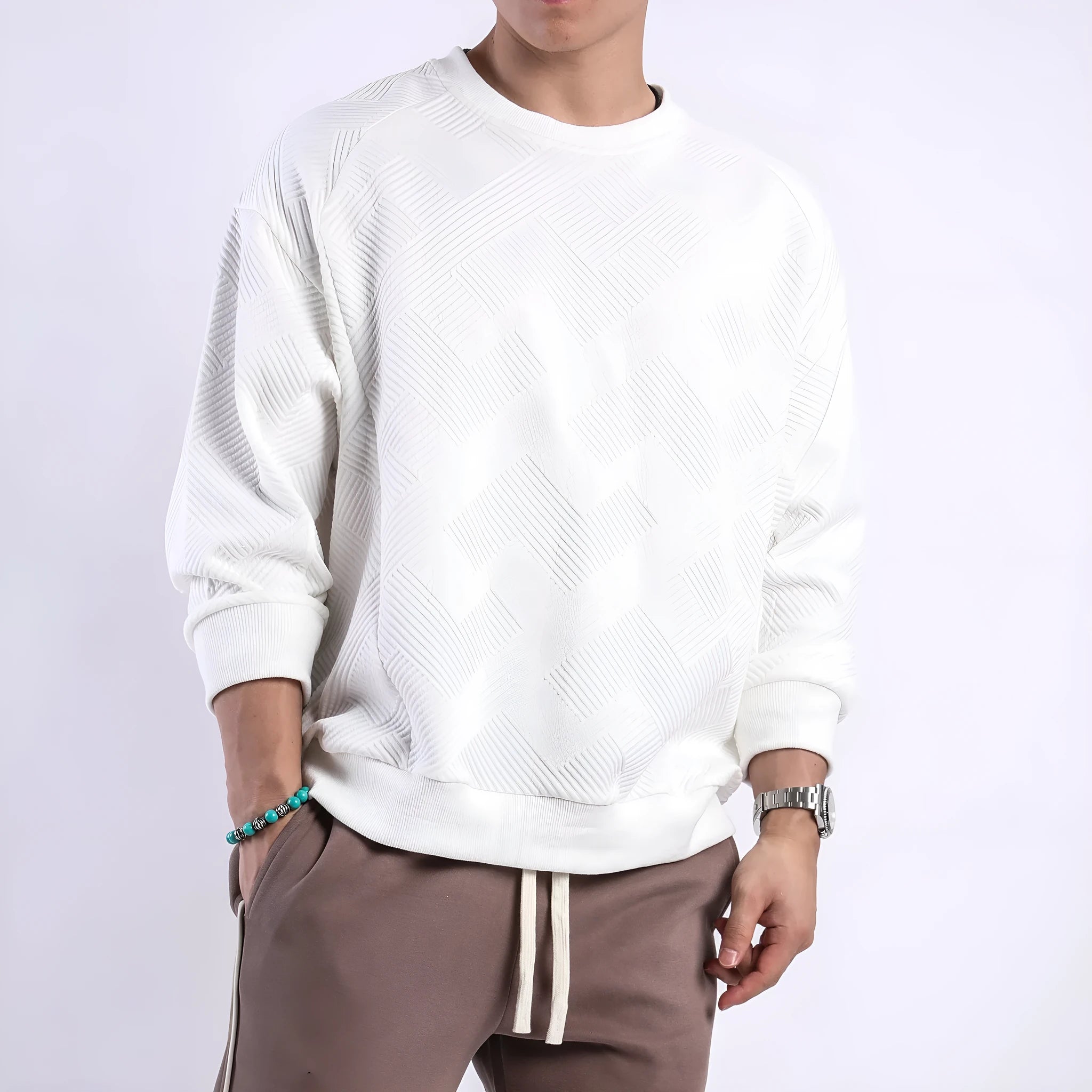 Man wearing a loose-fitting army green twill jacquard long-sleeved pullover sweater.