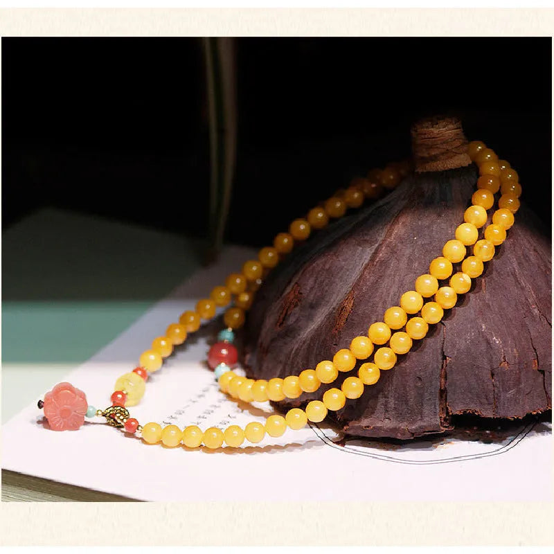 Yellow amber bracelet with 5mm round beads and animal zodiac design on wrist
