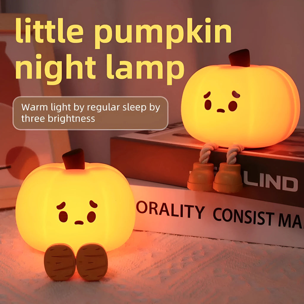 Pumpkin-shaped silicone night light with rechargeable battery on a bedside table