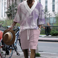 Man wearing a printed drop-shoulder knitted top and matching shorts from a leisure suit set.