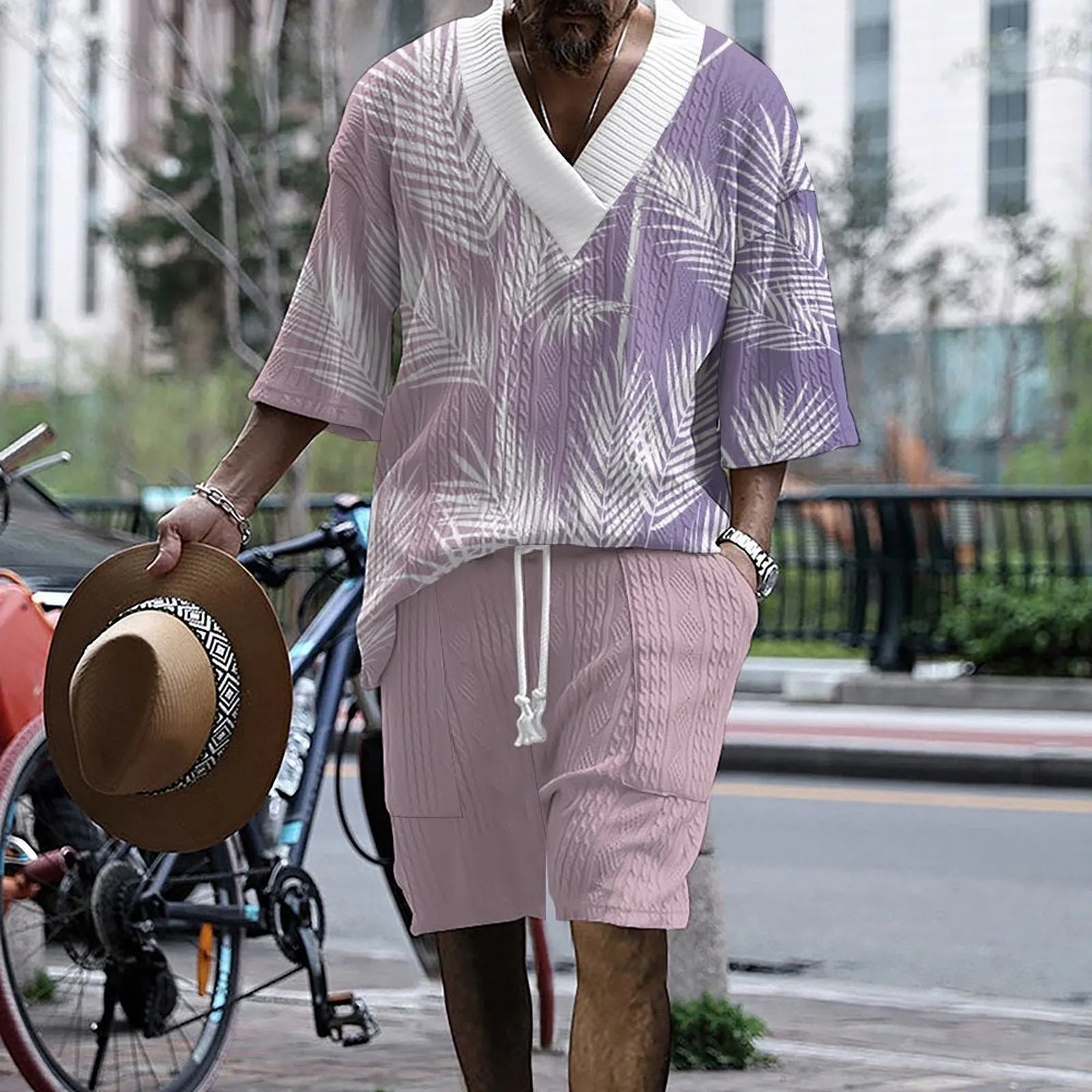 Man wearing a printed drop-shoulder knitted top and matching shorts from a leisure suit set.