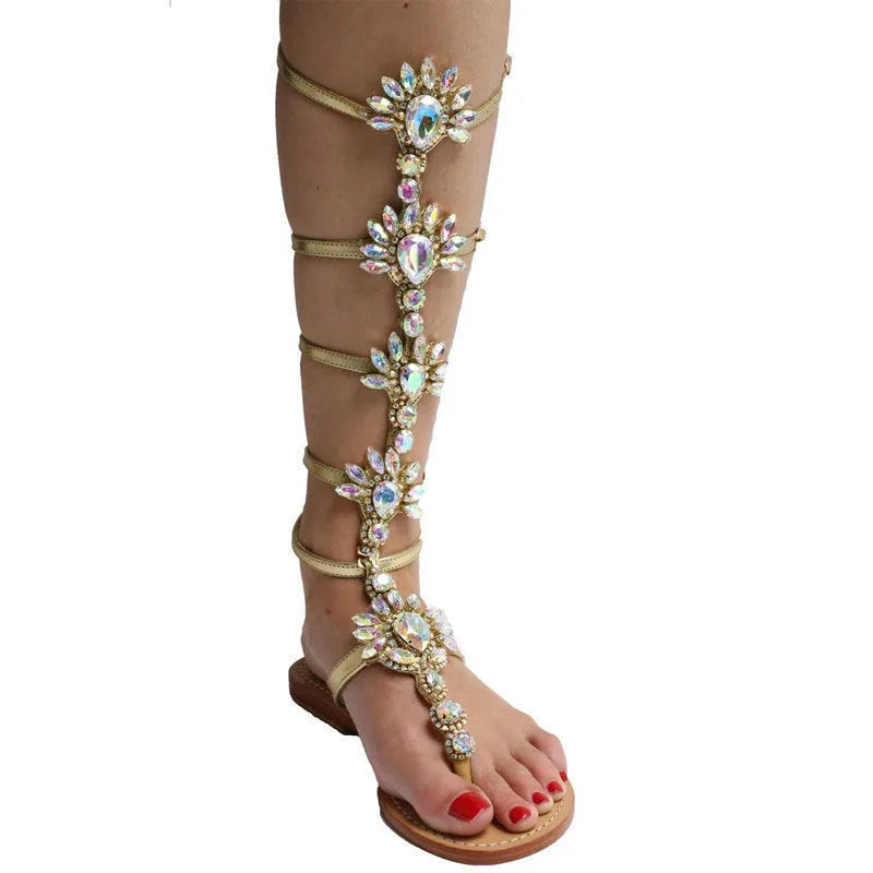 Women's flat roman sandals with rhinestone upper, round toe, in silver colour on plain background