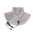 Electric heating shawl in gray folded on a surface with USB cable visible