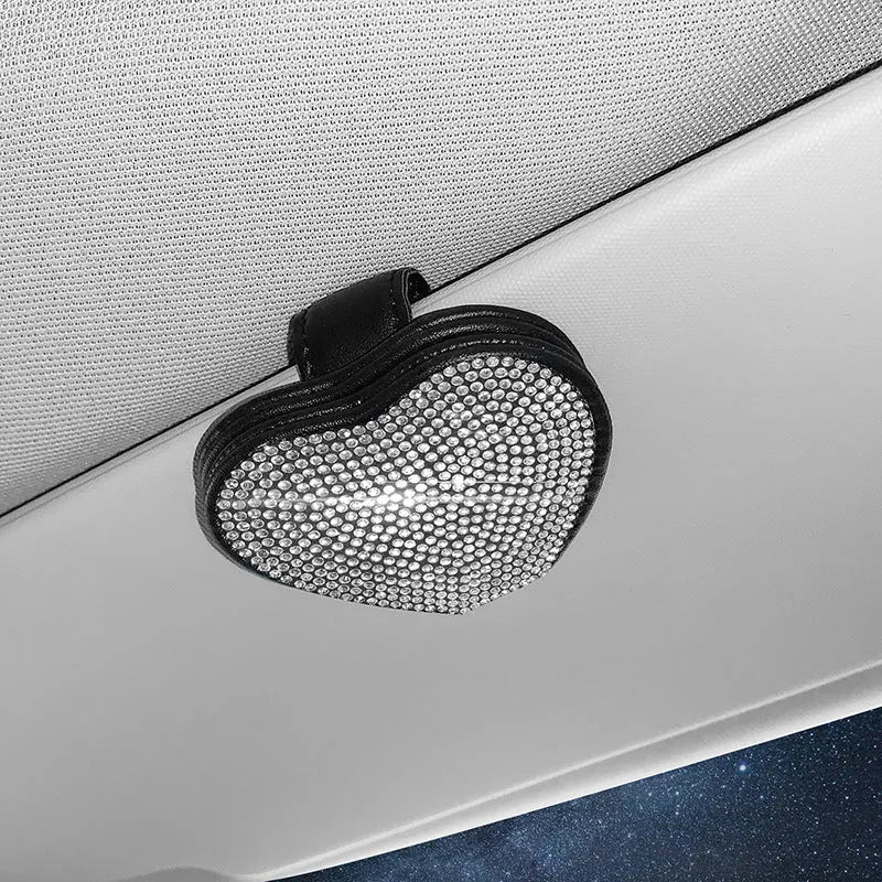 A black PU leather magnetic storage clip with a diamond pattern on a car sun visor, holding a pair of sunglasses.