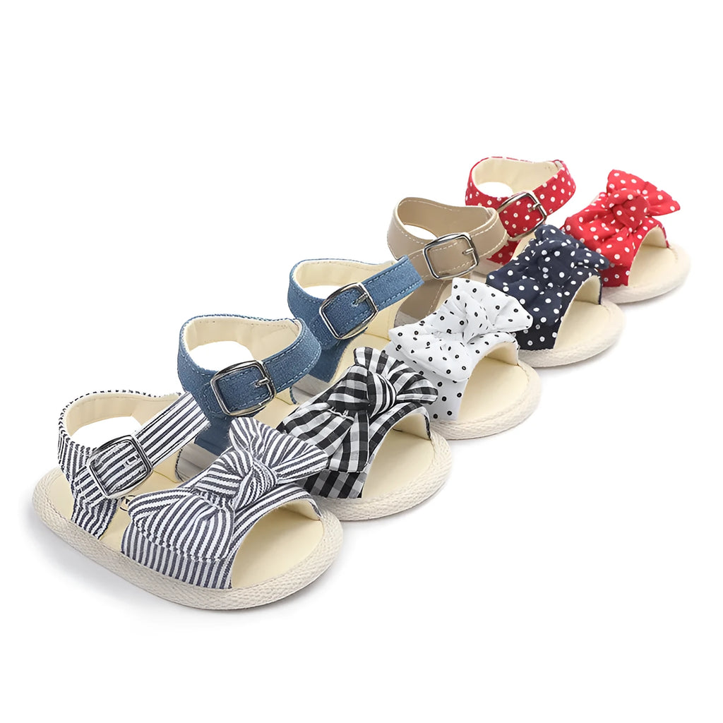 Black and white velcro fastening baby shoes for toddlers, showing low tube height design.