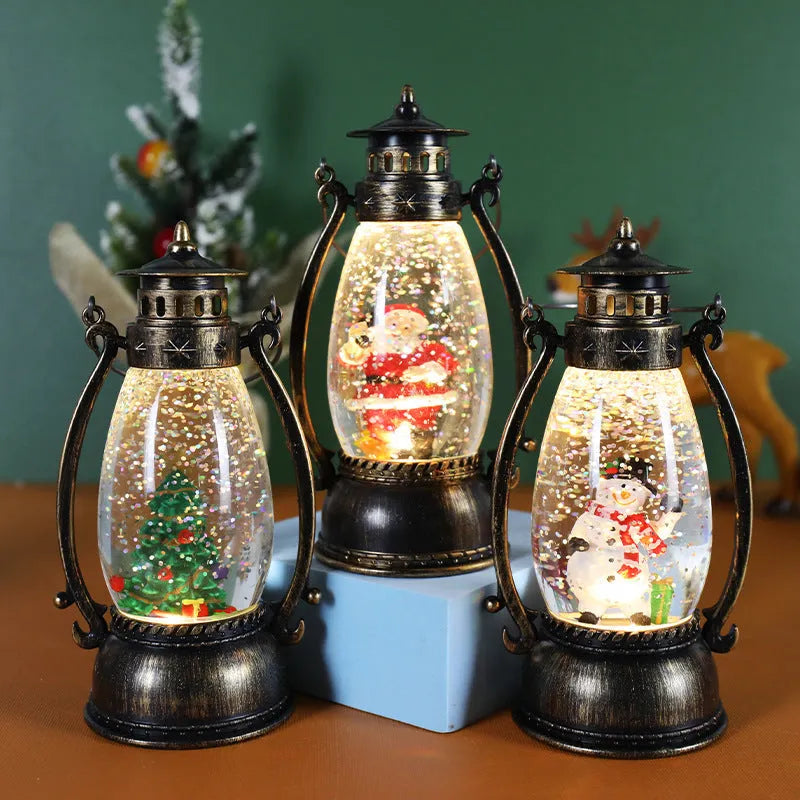 Plastic crystal ball LED oil lamp Christmas decoration showing internal snowman scene on a desktop.