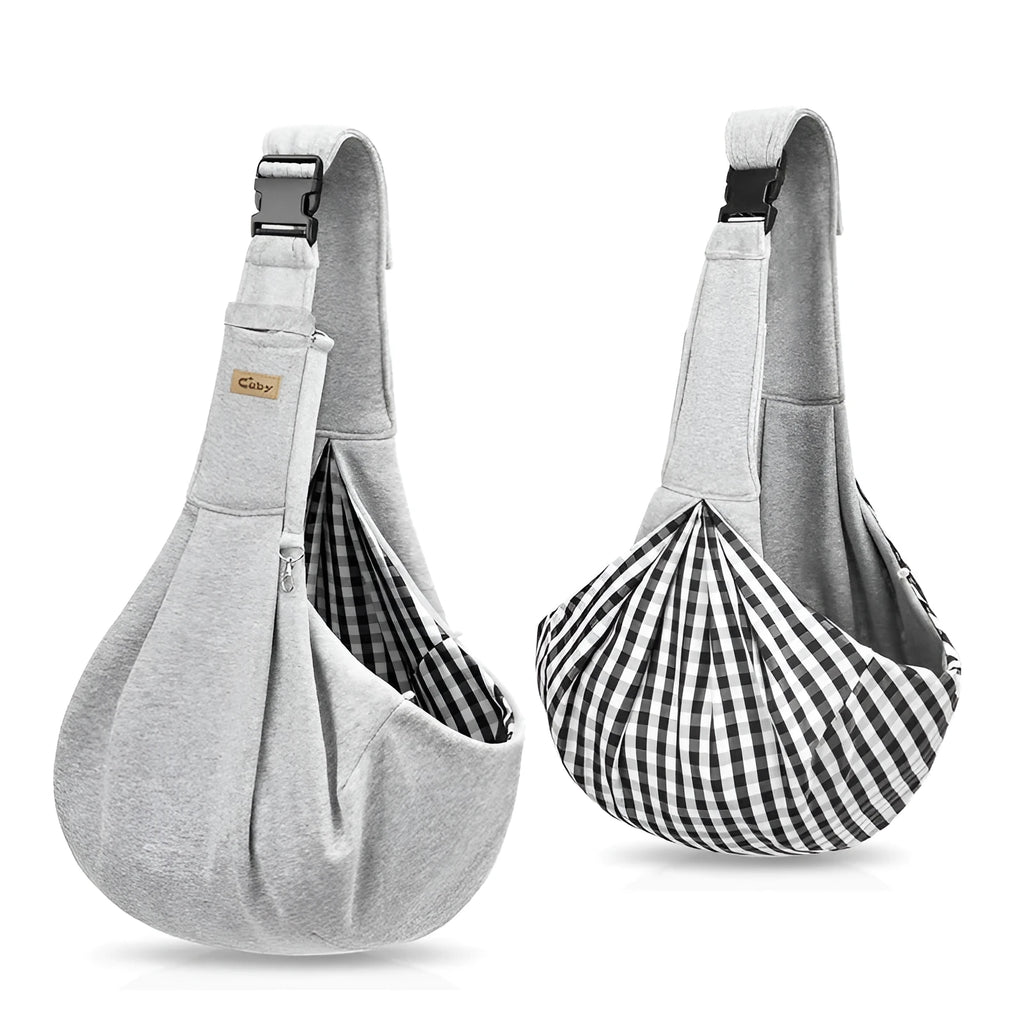 Light grey polyester pet sling carrier with cell phone pocket, worn around waist, holding a small dog