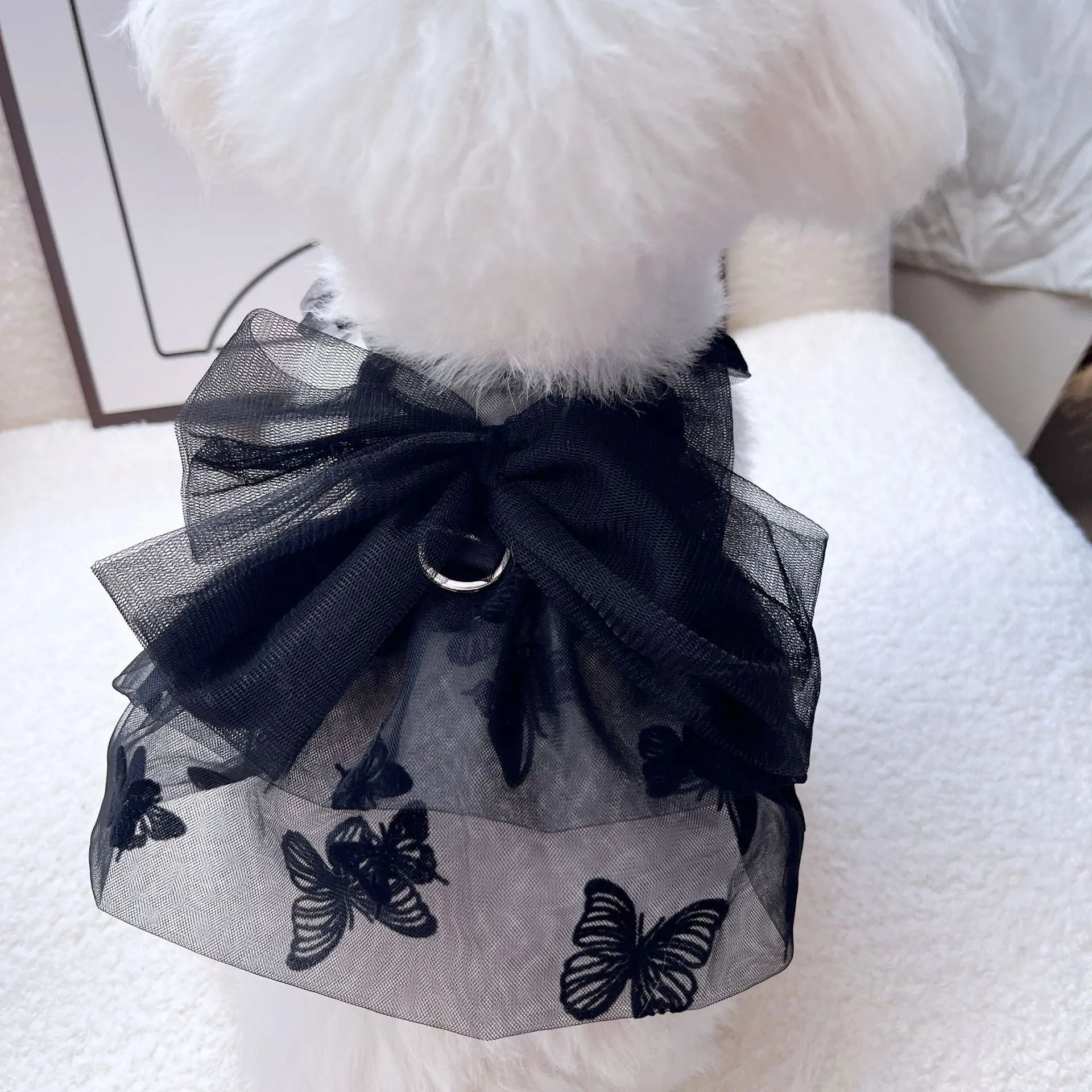 Black tiered tulle princess skirt on a small dog, showing the gauze layers and fit.