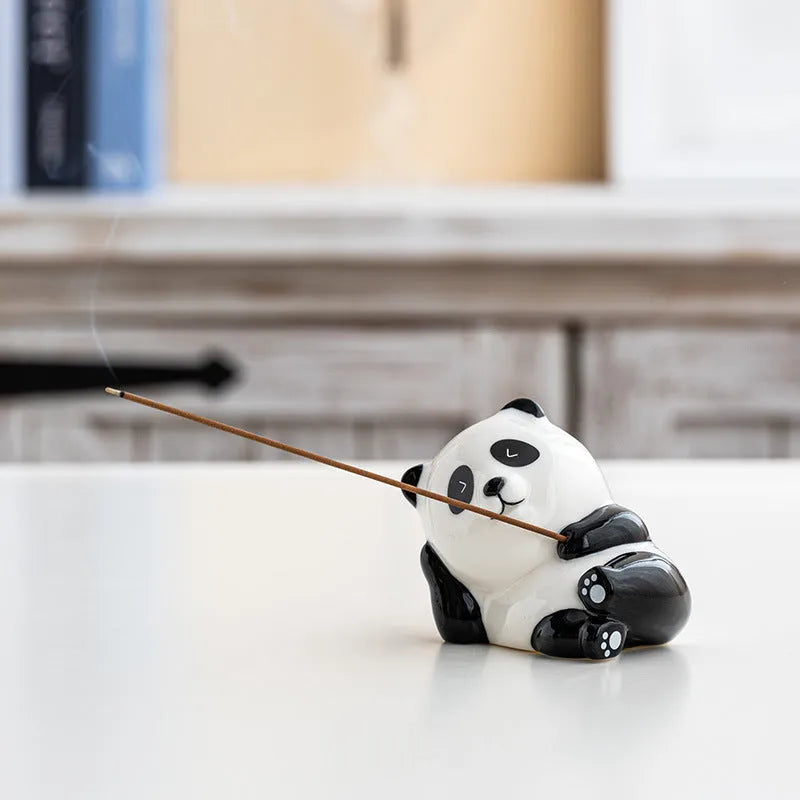 Ceramic panda incense burner with closed eyes on a desk, 8.5cm tall, for office aromatherapy