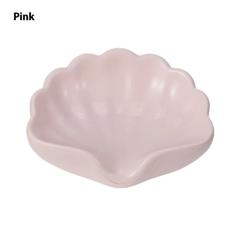 White or pink plastic shell-shaped soap dish for bathroom organisation