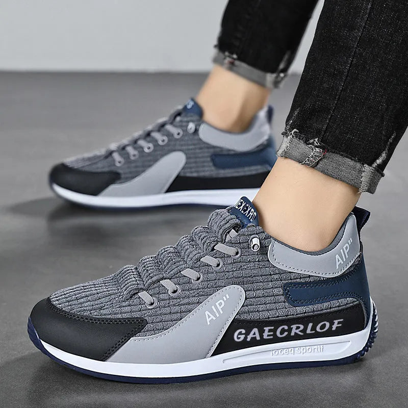 Men's green and grey running shoes with mesh upper and lace-up closure on neutral background