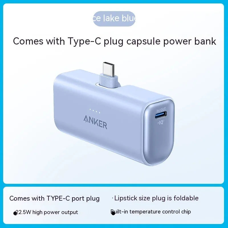 Small capsule-shaped power bank in multiple colours showing built-in foldable USB-C cable and compact size.
