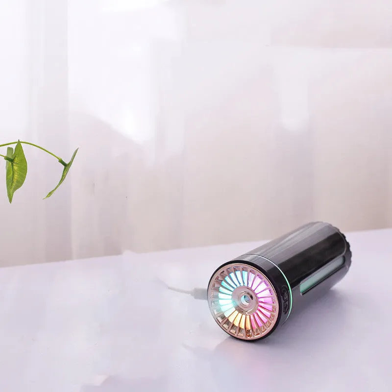 Black wireless portable humidifier with colourful lights beside car cup holder