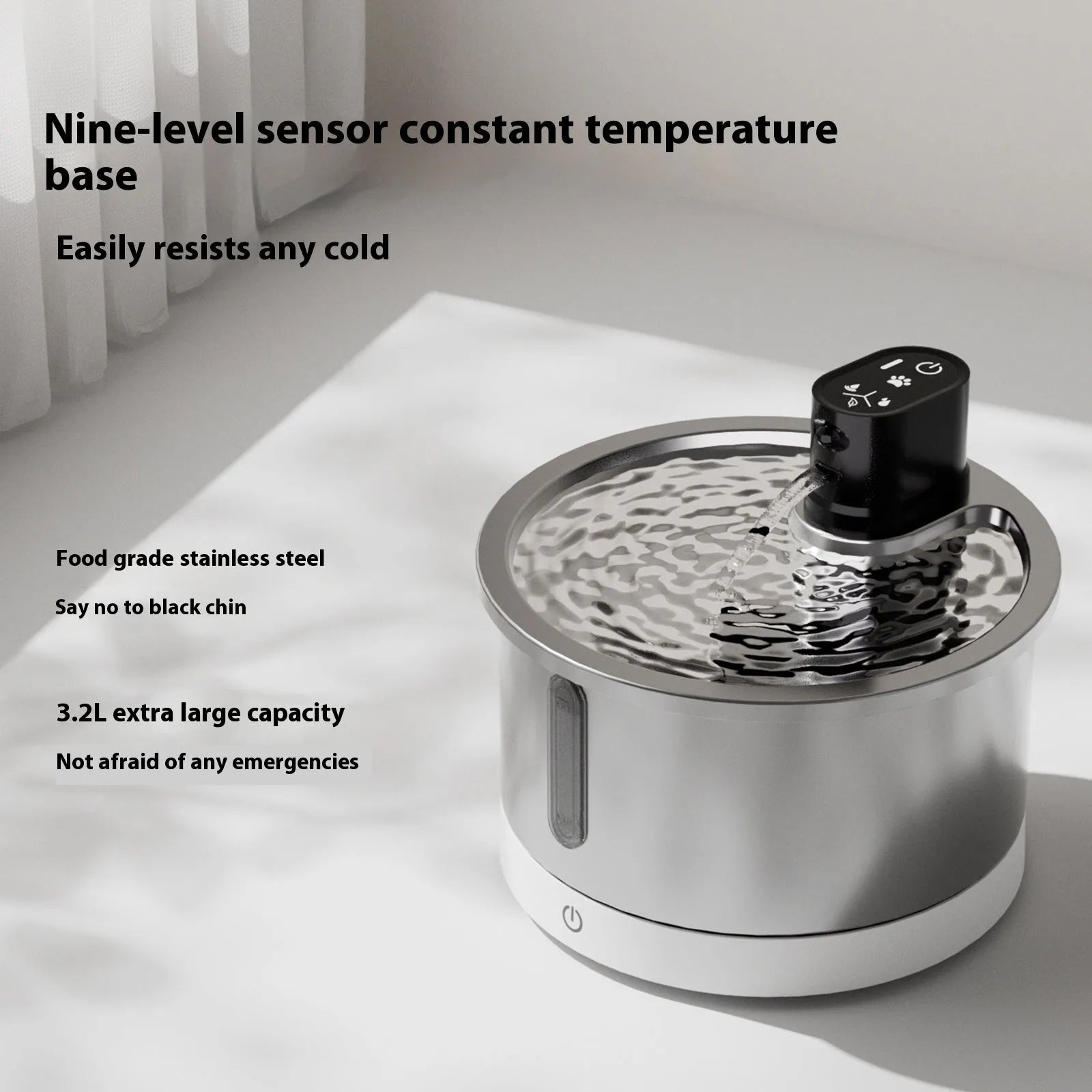 White stainless steel cat water fountain with constant temperature heating base on a table.