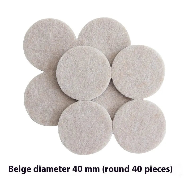 Assortment of beige round and square plastic non-slip furniture foot pads on a wooden floor.