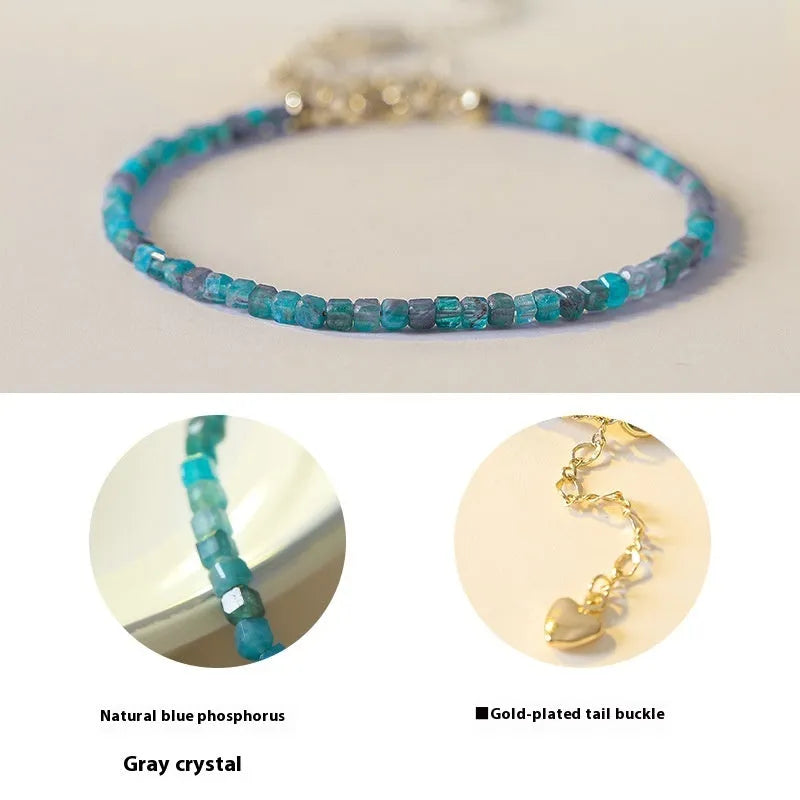 Women's blue and grey apatite crystal bracelet with diamond-cut stones on a wrist.