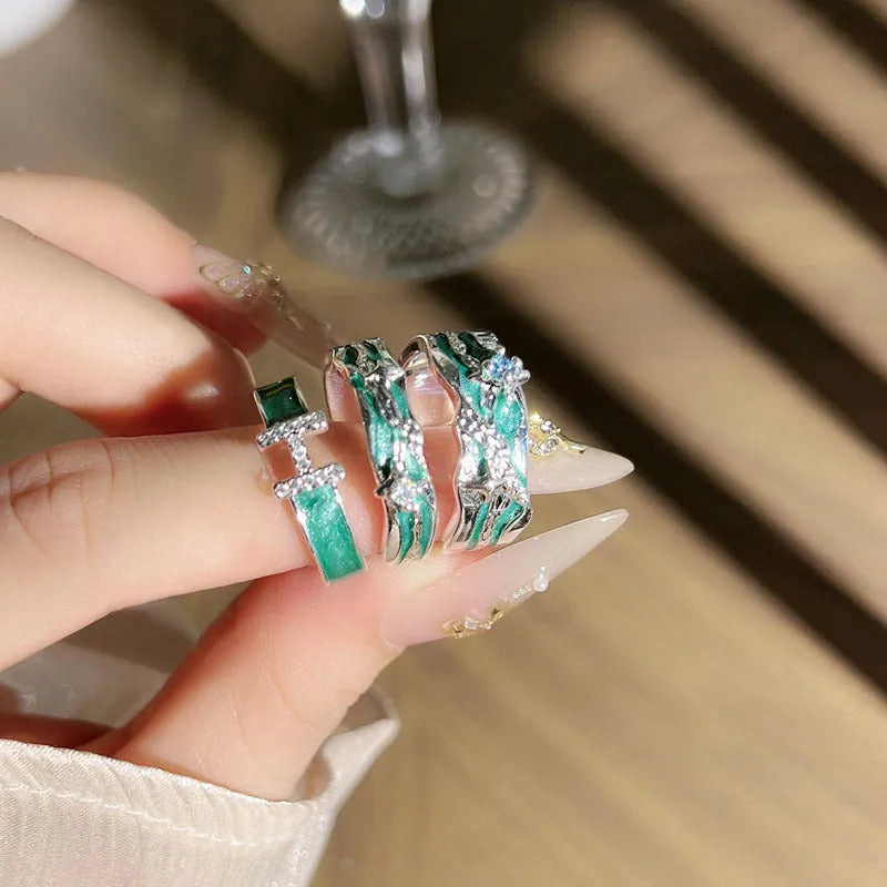 Mint green enamel asterism ring with custom text on copper, showing folding and asymmetric details.