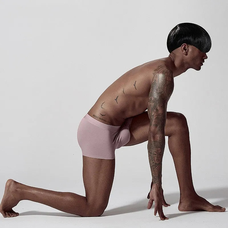 Men's seamless modal one-piece underwear in white, pink, or green with mid-waist hip lifting design