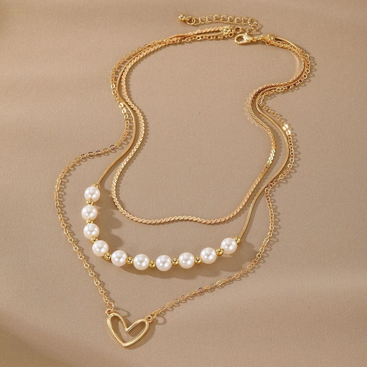 Gold tone heart-shaped pendant necklace with pearl chain, vintage love symbol jewellery