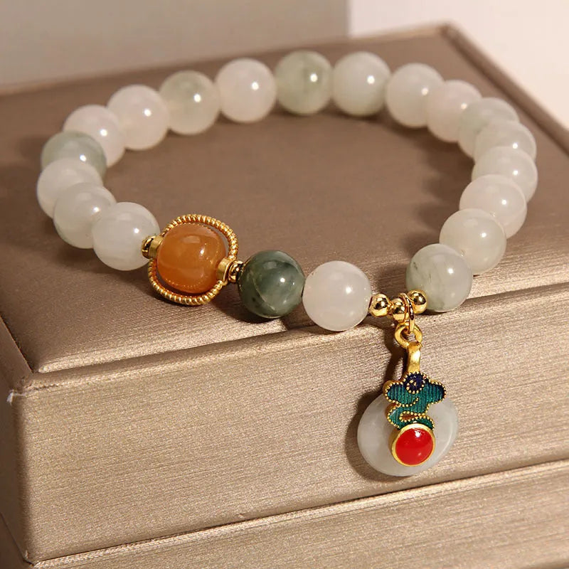 Women's ice jade crystal bracelet with a pearl and a detailed Xiangyun peace jade buckle.
