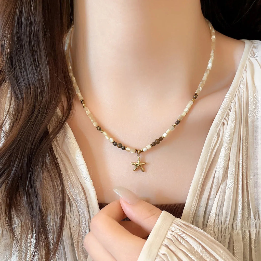 Titanium steel starfish pendant necklace with natural shell and tigereye beads on a 41-50cm chain.