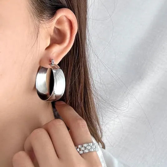 Widened curved stainless steel earrings with titanium construction in gold or steel colour, 25mm or 30mm diameter