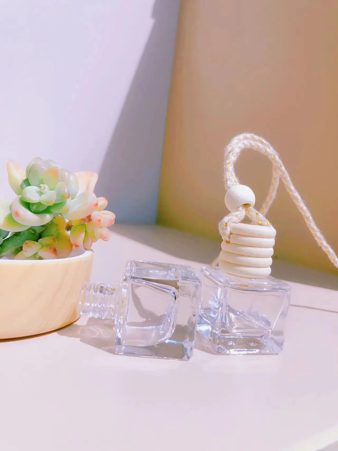 Glass car perfume pendant fragrance diffuser in cylinder, diamond, flat drum, and square styles.