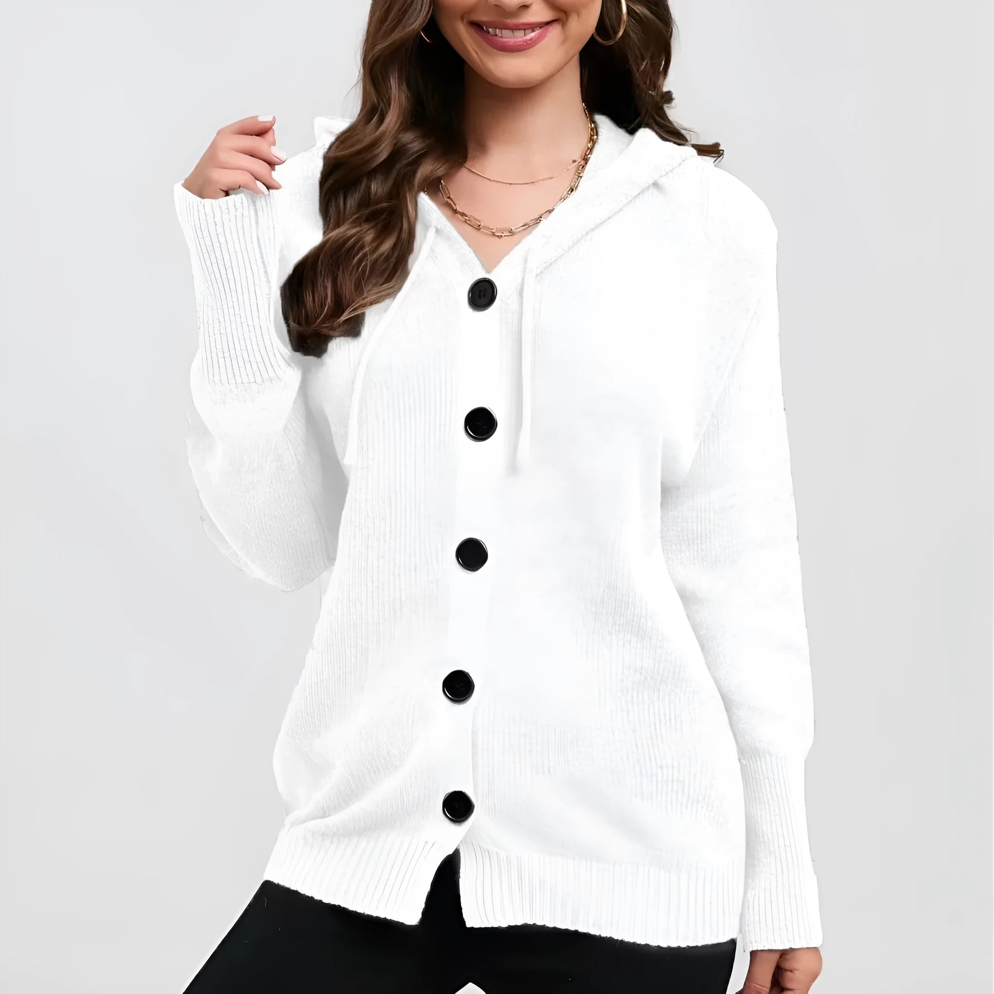 Women's loose fit thick cotton hooded cardigan sweater in a solid colour on a hanger.