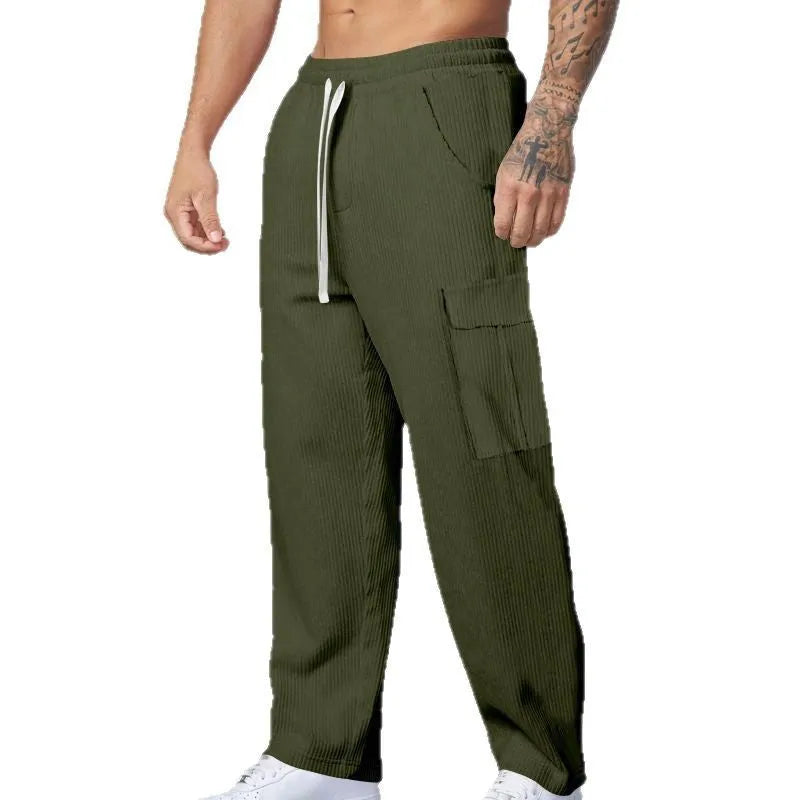 Men's navy blue corduroy cargo trousers with a drawstring waist and wide straight legs laid flat.
