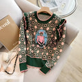 Green printed loose-fit sweater for women, shown on a hanger.