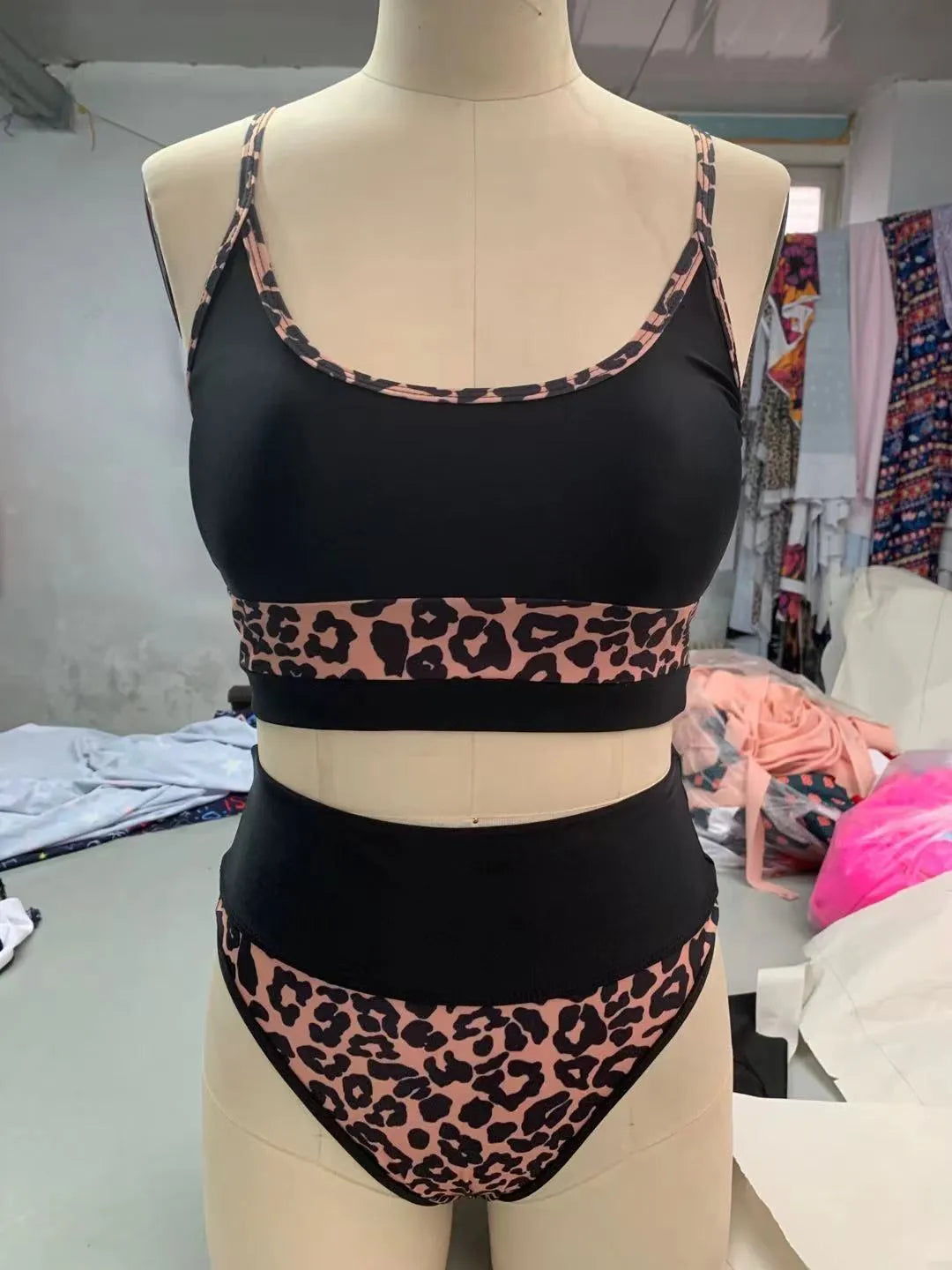 Women's high-waisted leopard print bikini swimsuit top and shorts on a white background.