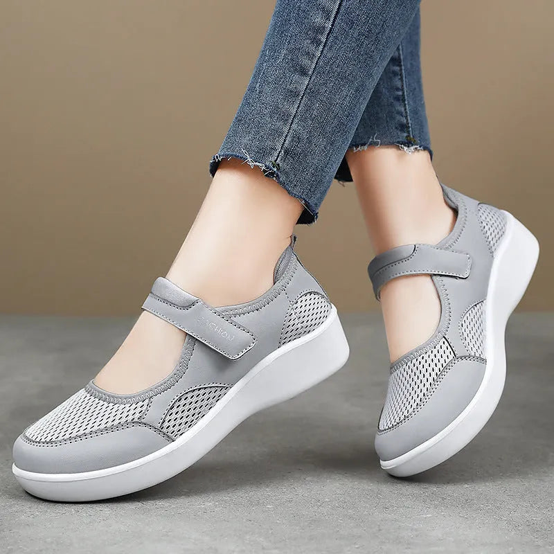 Women's low-top casual shoes in grey with mesh upper and Velcro strap.