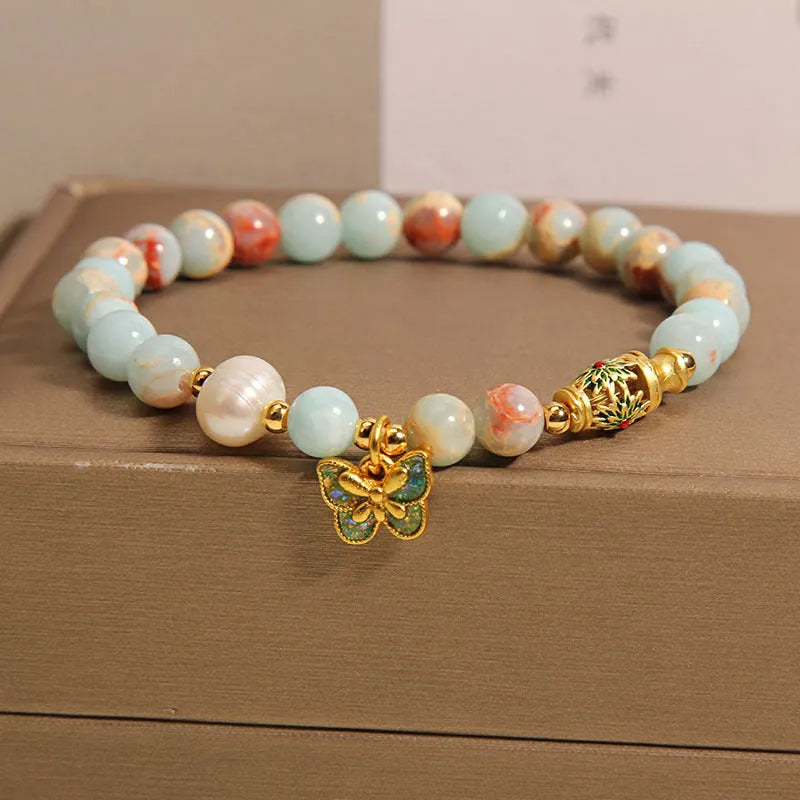 Blue women's bracelet with Shoushan Stone and freshwater pearl butterfly design featuring adjustable closure