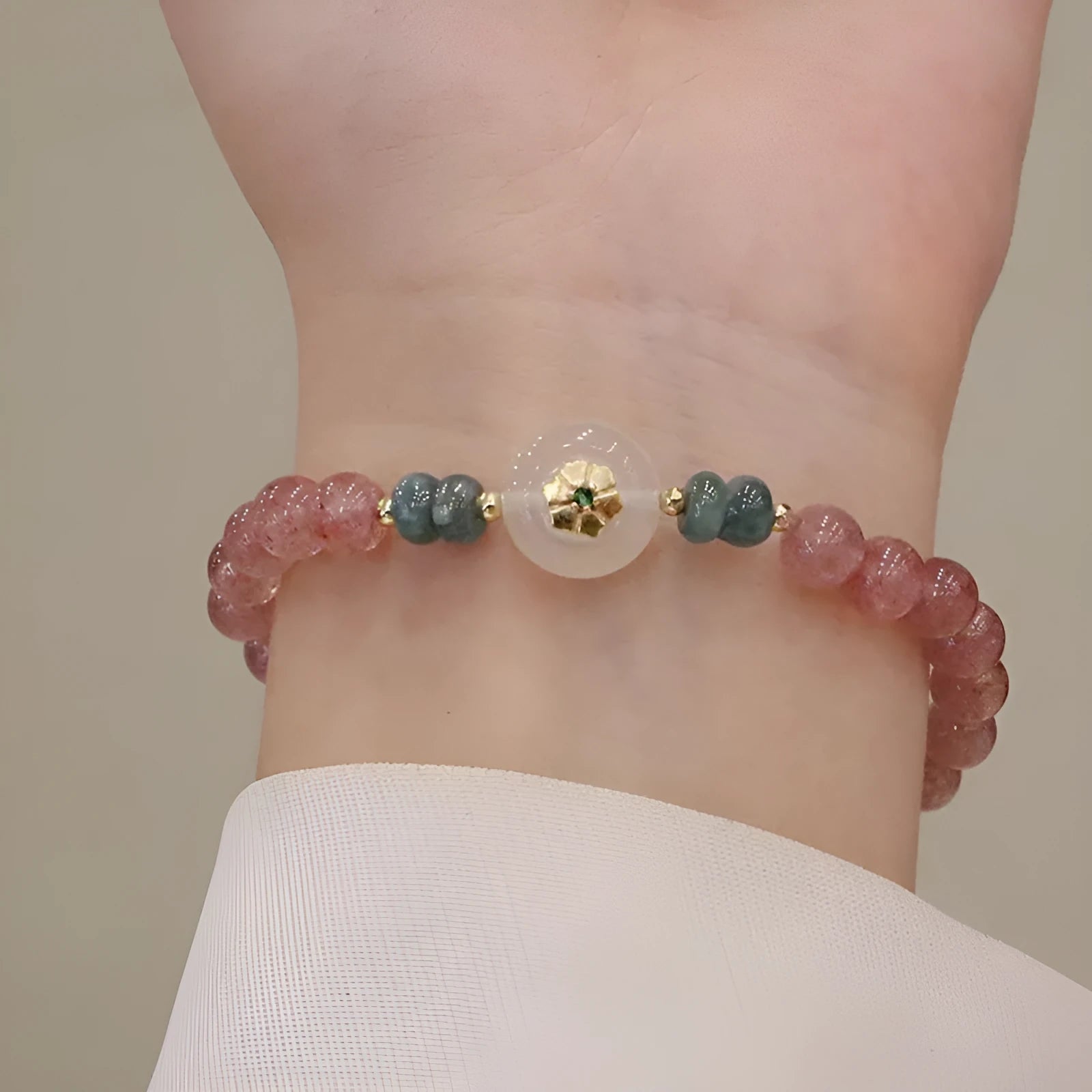 Strawberry quartz bracelet with blue water emerald pendant and Chinese geometric motifs