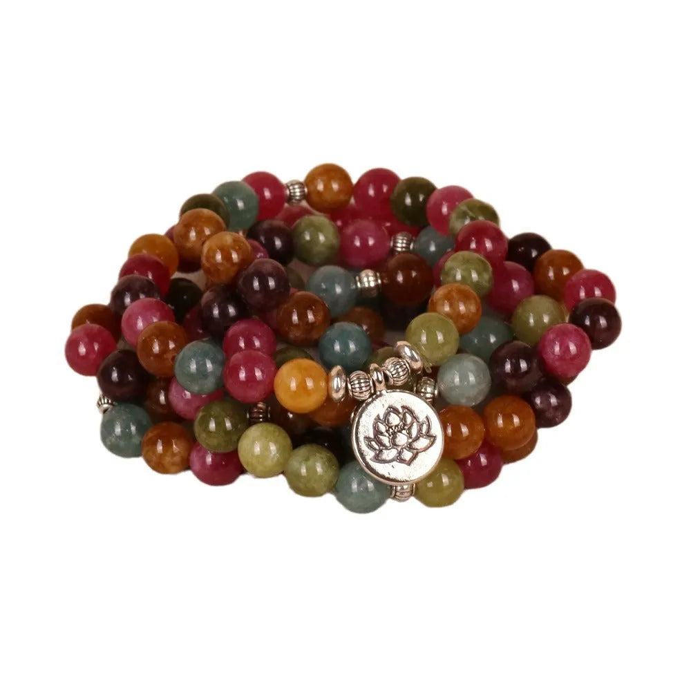 Multi-layer bracelet with 108 dark green tourmaline beads on a silver-toned alloy chain in a lotus design.