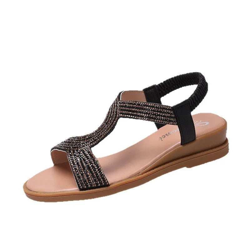 Women's gold patent leather beach sandals with rhinestone decoration and a non-slip sole.