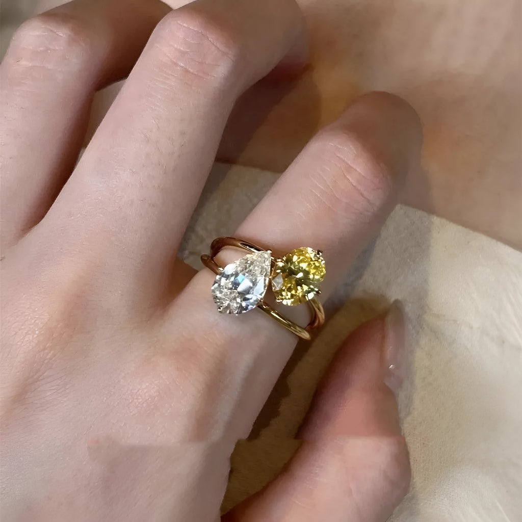 Geometric copper open ring for women with a water drop double Sheng stone in a pop style.